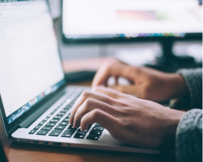 person typing on a laptop